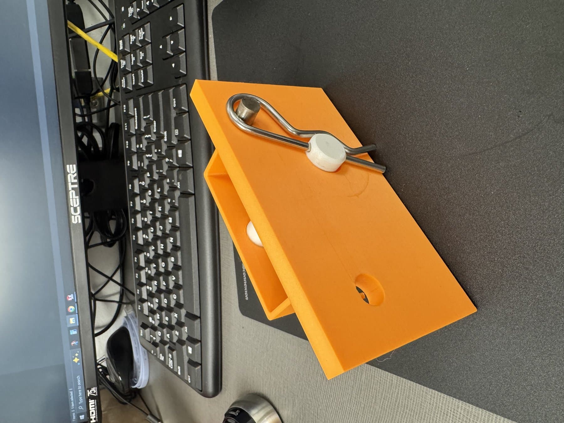 3D printed prototype of the redesigned housing with retention pin installed