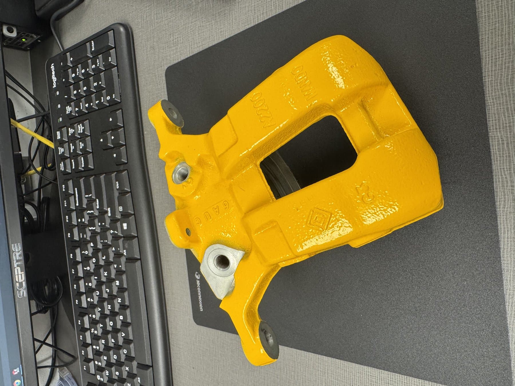 Coated part with masking insert removed, showing protected bore